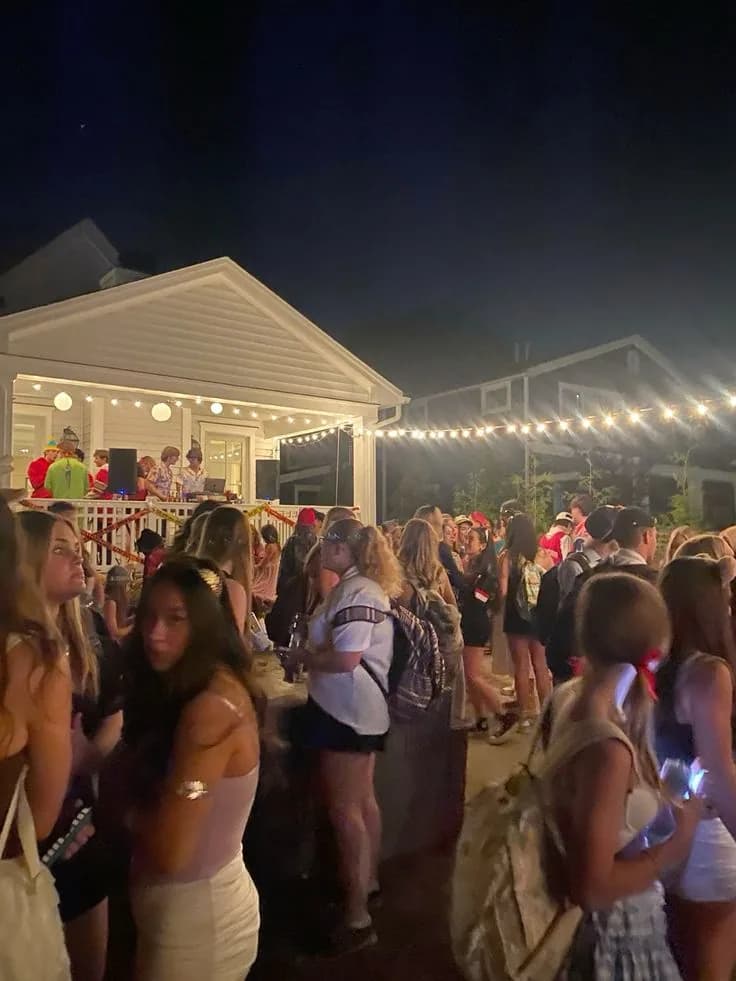 Friends dancing under string lights at a backyard party